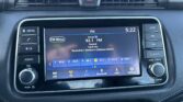 In-car infotainment screen showing FM radio at 92.1 with preset buttons along the bottom and surrounding physical controls and vents on the dashboard.