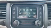 In-car stereo center console displaying FM radio 103.7 and the time 11:51, with labeled buttons for RADIO, MEDIA, COMPASS, and SETTINGS.