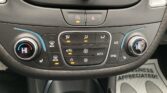 Center console climate controls: left and right temperature dials set to HI with blue/red accents, plus a row of buttons for defrost, A/C, fan, Auto, and SYNC; hazard light button in the middle.