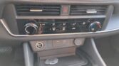 Car interior center console with dual air vents, hazard button, and climate control dials below; starts/stop button on left and USB ports nearby (storage tray beneath).