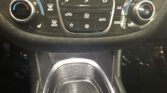 Center console climate control panel: left temperature dial, blue-to-red gradient, middle row of buttons (defrost, rear window, fan speeds), right temperature dial with A/C and dual-zone indicators visible.