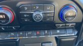 Car climate control panel with dual temperature dials (HI) and center fan knob, plus A/C, defrost, and rear window buttons.