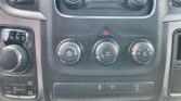Center dashboard: climate control dials, hazard button, gear selector on left, and 4WD controls visible.