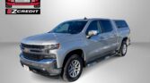Silver Chevrolet pickup truck with EZ Credit logo on a gray background and the promo line 'APPLY, ARRIVE & DRIVE!' in red lettering at the bottom.