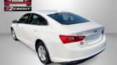 White Chevrolet Malibu seen from rear three-quarter angle, with Easton Motors EZCredit branding in the top-left and 'APPLY, ARRIVE & DRIVE' at the bottom.