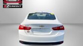 Rear view of a white Chevrolet sedan with Easton Motors EZCredit logo in the top-left and the red slogan 'APPLY, ARRIVE & DRIVE!' along the bottom.