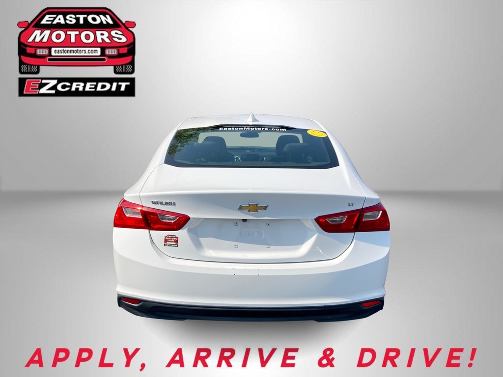 Rear view of a white Chevrolet sedan with Easton Motors EZCredit logo in the top-left and the red slogan 'APPLY, ARRIVE & DRIVE!' along the bottom.