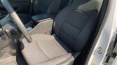 Front interior of a car showing the driver and passenger seats, steering wheel, and center console area. early morning light shows clean, black upholstery.
