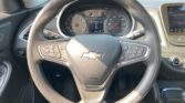 Steering wheel with Chevrolet emblem, mounted controls, and instrument cluster visible behind in a car interior