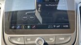 Infotainment screen in a car showing FM radio at 103.7 and a message 'No Phone Connected' with control icons along the bottom edge of the display.